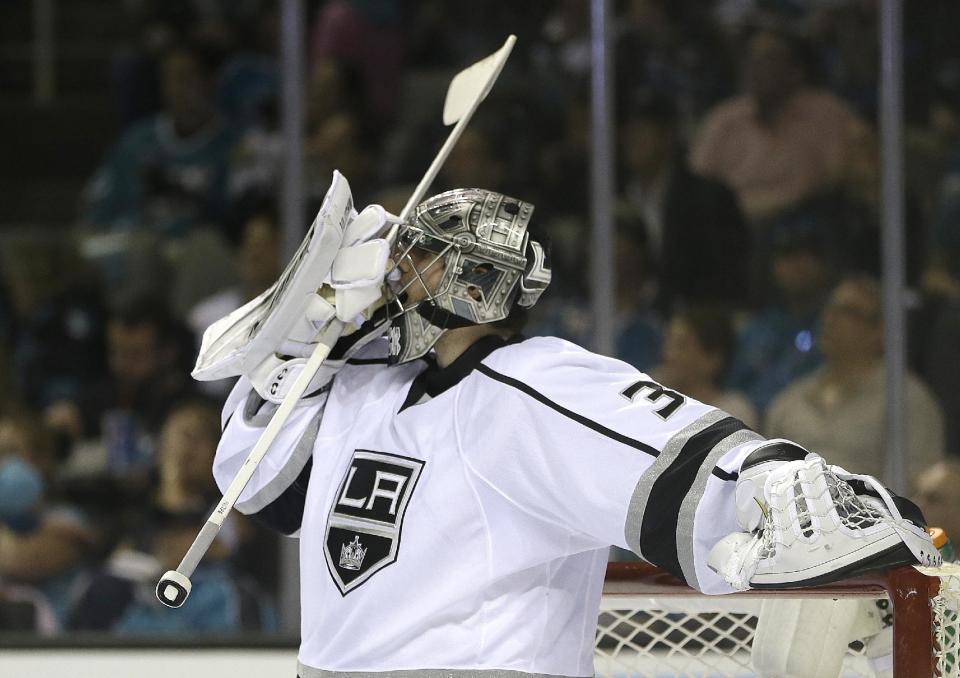 Los Angeles Kings goalie Jonathan Quick adjusts his mask during the second period of Game 1 of an NHL hockey first-round playoff series against the San Jose Sharks Thursday, April 17, 2014, in San Jose, Calif. (AP Photo/Ben Margot)