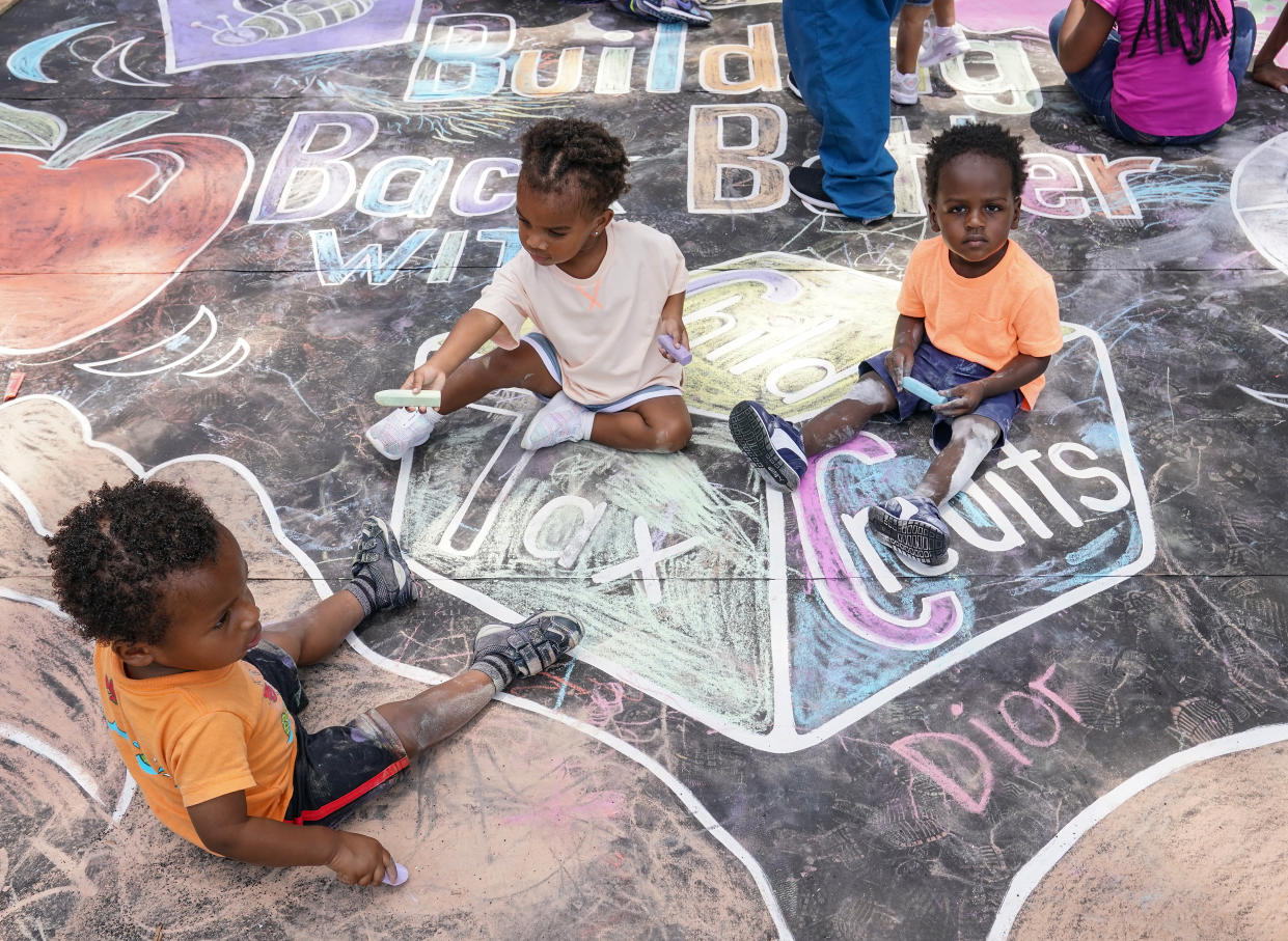 WASHINGTON, DC - JULY 14: Children from the KU Kids Deanwood Childcare Center complete a mural celebrating the launch of the Child Tax Credit on July 14, 2021 at the KU Kids Deanwood Childcare Center in Washington, DC. (Photo by Jemal Countess/Getty Images for Community Change)