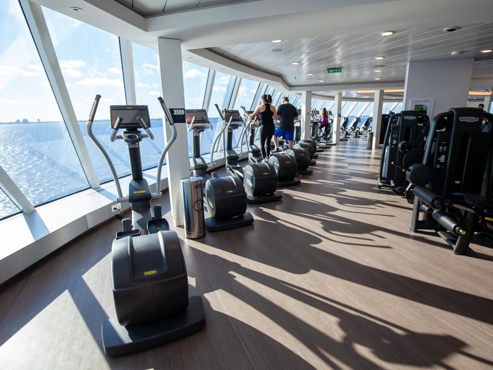 People inside the gym facing the ocean