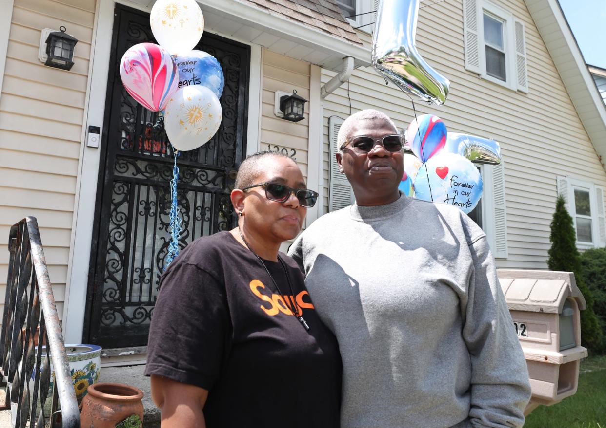 Terri McDowell, mother of LaTeris Cook, 27, and her wife, Kalandra, remember LaTeris as they stand in front of his father's home in Akron.  Cook was shot and killed during a mass shooting at an outdoor party shortly after midnight Sunday in Akron.