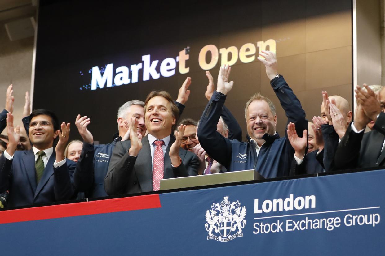 Bullish: Andy Palmer (C-R), CEO of Aston Martin applauds in celebration as the company was floated on the LSE on 3 October. Photo: Tolga Akmen/AFP/Getty Images.