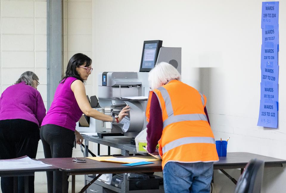 Deputy Director of City of Milwaukee Election Commission Paulina Gutierrez fixes a jammed tabulator containing ballots for the 2023 Wisconsin spring general election on April 4, 2023, at the Central Count in Milwaukee. Under a new bill, central count communities would be required to begin processing absentee ballots on Monday.