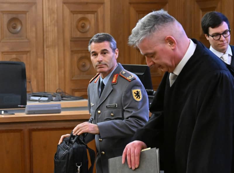 Former KSK commander Brigadier General Markus Kreitmayr (L) stands in the courtroom with his defence lawyer Bernd Muessig before the start of his trial. A criminal case against a former commanding officer of Germany's elite KSK special forces over thousands of rounds of missing ammunition has been dropped in exchange for an €8,000 ($8,600) charitable donation. Bernd Weißbrod/dpa