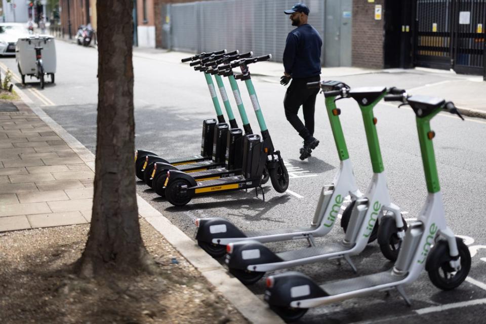 A row of both Lime and Tier electric scooters (Getty Images)