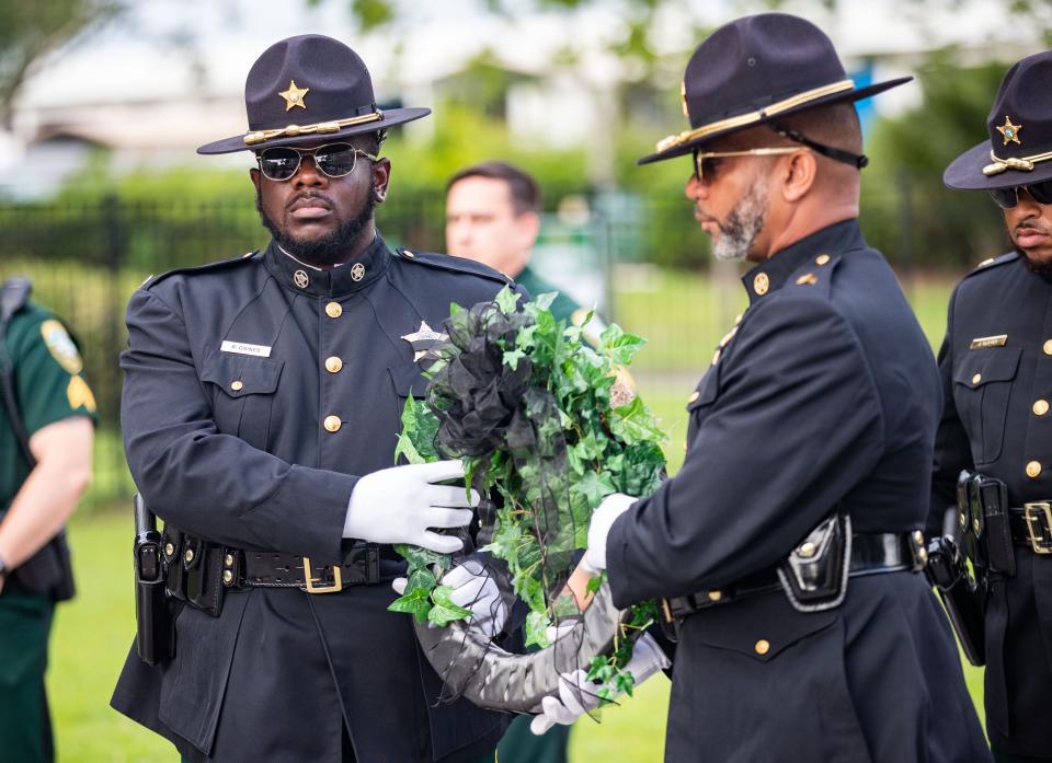 The Leon County, Florida, Sheriff's Office Honor Guard present a wreath honoring Correctional Deputy Michael Nowak one year following his death Aug. 12, 2022. Nowak contracted COVID-19 while serving the line of duty and later succumbed to his illness.