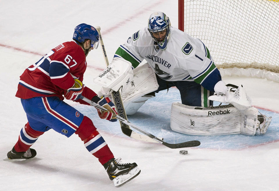 Vancouver Canucks goaltender Roberto Luongo stops a penalty shot by Montreal Canadiens' Max Pacioretty during the second period of an NHL hockey game Thursday, Feb. 6, 2014, in Montreal. (AP Photo/The Canadian Press, Graham Hughes)