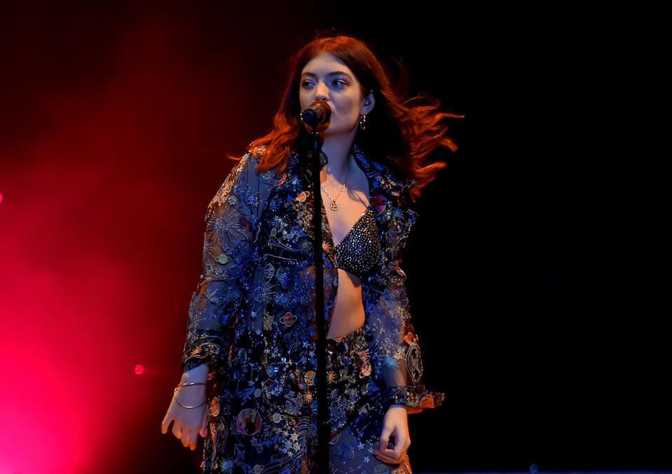 A closeup of Lorde performing