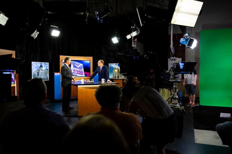 Montana Governor and 2020 Democratic presidential candidate Steve Bullock, left, and WHO's Dave Price talk before a televised town hall meeting at WHO on Wednesday, June 26, 2019, in Des Moines.