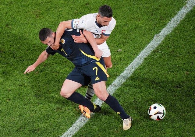 John McGinn battles for the ball with Switzerland's Fabian Schar