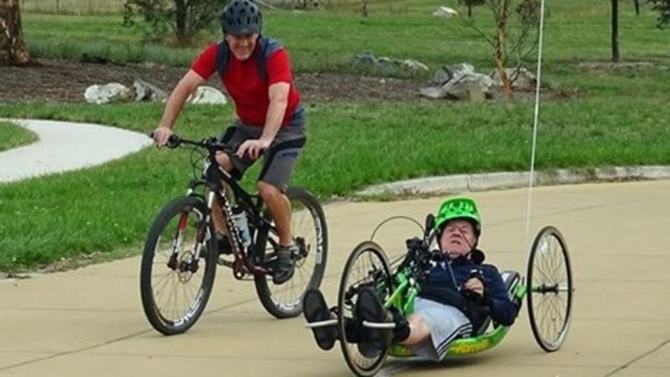 andrew kerec and his father using a hand-cycle