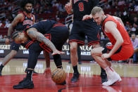 Chicago Bulls forward DeMar DeRozan, left, reaches to recover the ball lost by Houston Rockets center Jock Landale, right, during the first half of an NBA basketball game Thursday, March 21, 2024, in Houston. (AP Photo/Michael Wyke)
