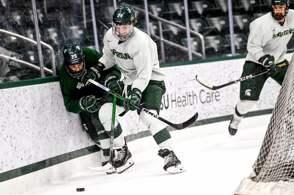 Michigan State's Gavin O'Connell, left, and James Crossman battle for the puck in practice during hockey media day on Wednesday, Sept. 27, 2023, at Munn Arena in East Lansing.