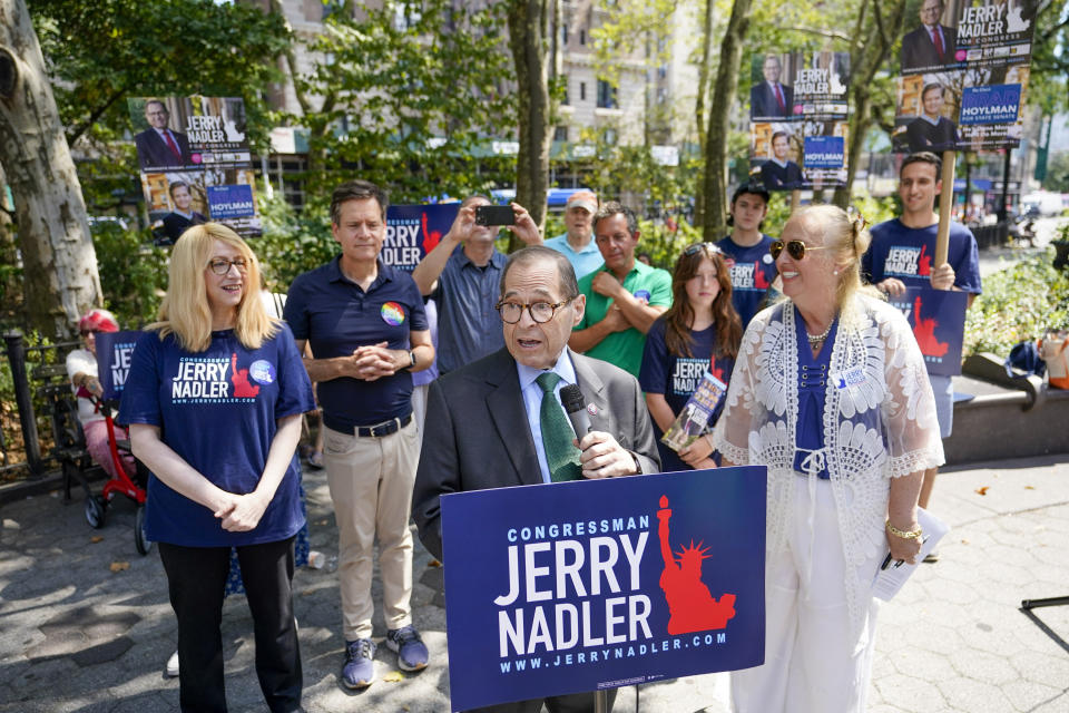 Rep. Jerry Nadler speaks at a rally, with supporters holding signs featuring his name.