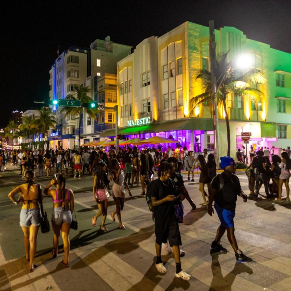 Crowds walk along Ocean Drive during spring break in Miami Beach on March 18, 2023.