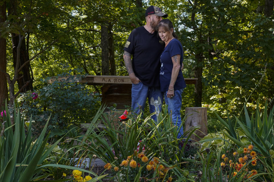 Brian and Karen Goodwin stand for a portrait near a memorial for motorcycle riders that includes the name of her son, Austin Hunter Turner, along U.S. Highway 421, Friday, Sept. 22, 2023, in Shady Valley, Tenn. For years, the couple had believed the story they’d been told -- that Hunter had died of a drug overdose. But after reviewing documents and videos obtained by AP, they are now convinced he didn’t die from drugs – they believe he was killed by police force. (AP Photo/George Walker IV)