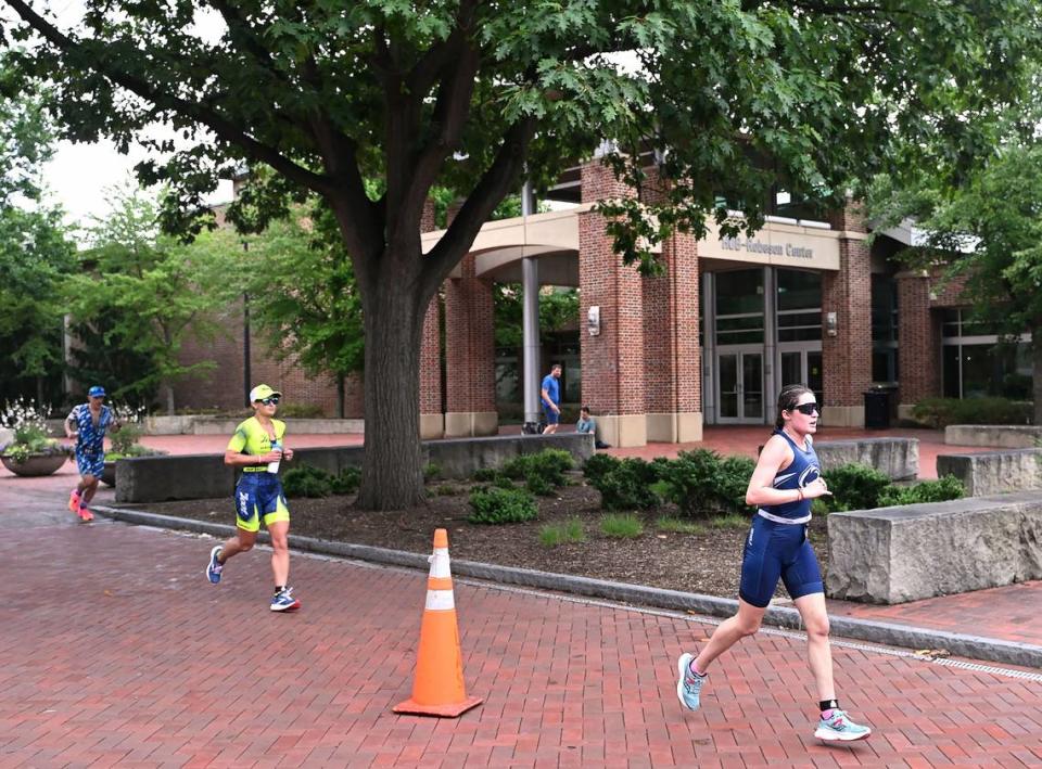 Participants in the Ironman 70.3 Pennsylvania Happy Valley run past the HUB-Robeson Center on the Penn State campus Sunday, July 2, 2023. Steve Manuel/For the CDT