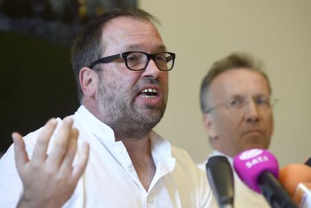 Doctor Stefan Schmiedel (L) and Ansgar Lohse, director of the polyclinic at the 'Universitaetsklinikum Hamburg-Eppendorf ' (University Clinic Eppendorf- UKE), address the media after an employee of the World Health Organisation (WHO) who contracted Ebola in Sierra Leone, arrived at the hospital in Hamburg, August 27, 2014. REUTERS/Fabian Bimmer