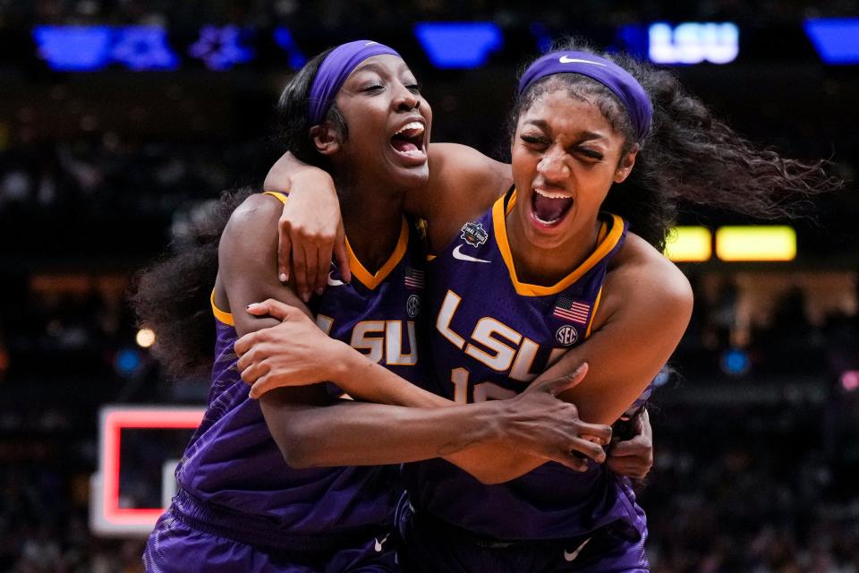 Flau'jae Johnson, left, celebrates with Angel Reese after LSU's victory over Virginia Tech.