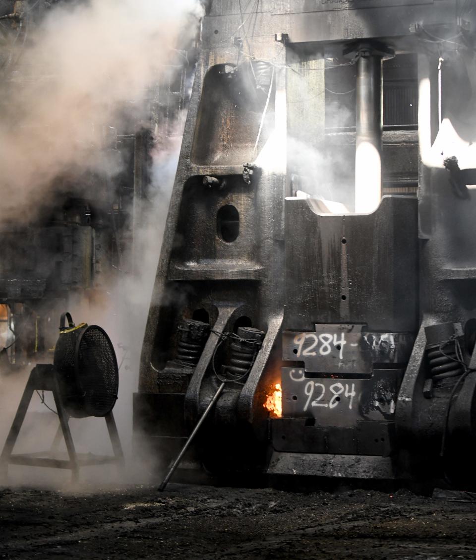 A hammer in the Canton Drop Forge plant in Perry Township presses together dies to forge a part from molten steel.