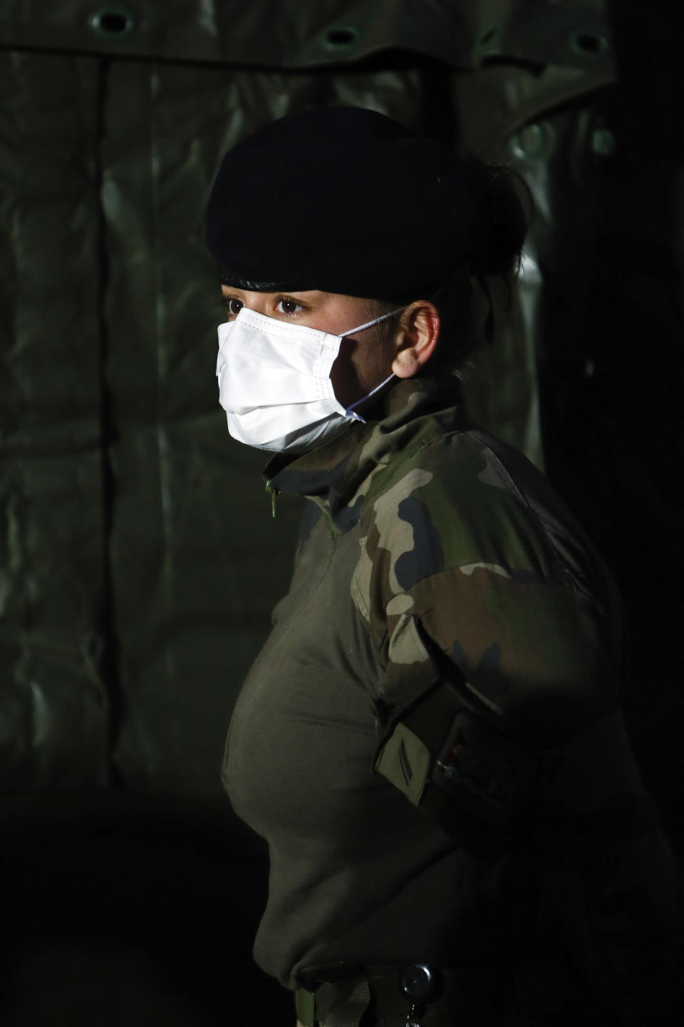 A soldier wears a face mask at the military field hospital in Mulhouse, eastern France, Wednesday, March 25, 2020. French President Emmanuel Macron launched a special military operation Wednesday to help fight the new virus in one of the world's hardest-hit countries. The new coronavirus causes mild or moderate symptoms for most people, but for some, especially older adults and people with existing health problems, it can cause more severe illness or death. (Mathieu Cugnot/Pool via AP)