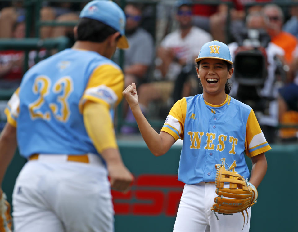 Honolulu, Hawaii pitcher Ka'olu Holt (14) celebrates with teammate Aukai Kea (23) after getting the final out of the first inning of the Little League World Series Championship baseball game against South Korea in South Williamsport, Pa., Sunday, Aug. 26, 2018. (AP Photo/Gene J. Puskar).