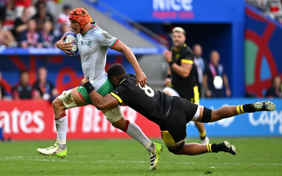 Taulupe Faletau (right) makes a last ditch tackle on Nicolas Martins of Portugal