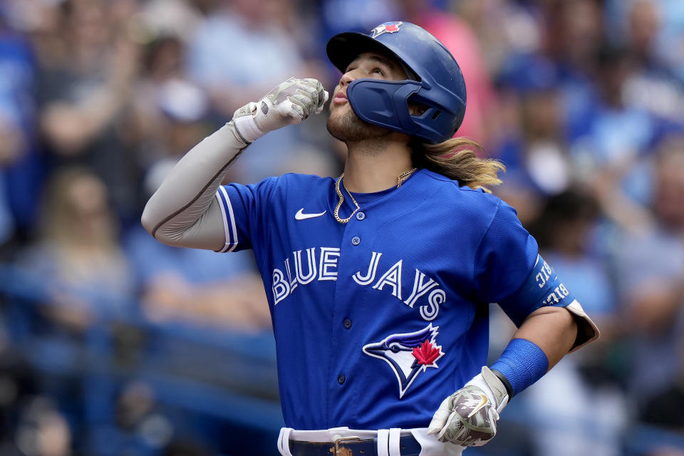 Toronto Blue Jays' Bo Bichette (11) celebrates his solo home run against the Cincinnati Reds during the fourth inning of a baseball game in Toronto, Saturday, May 21, 2022. (Frank Gunn/The Canadian Press via AP)