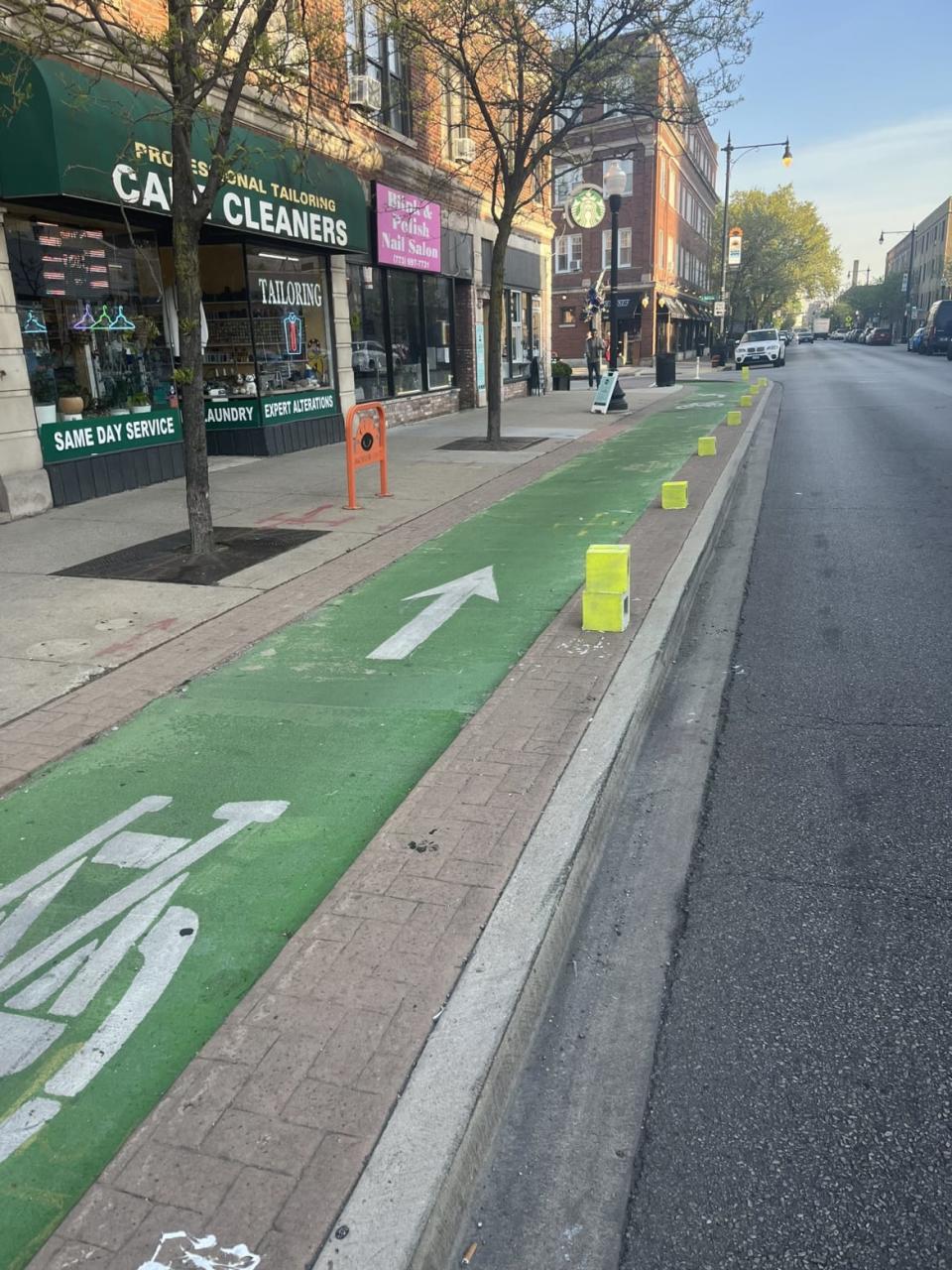 A bootleg bicycle lane barrier created by the People's CDOT out of cinder blocks. 