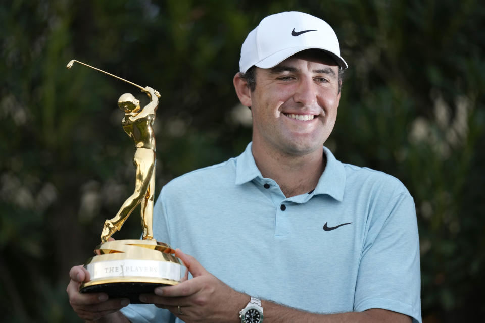 Scottie Scheffler celebrates after winning The Players Championship golf tournament, Sunday, March 12, 2023, in Ponte Vedra Beach, Fla. (AP Photo/Charlie Neibergall)