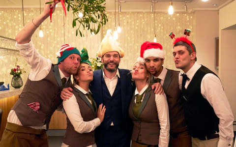 Staff at the First Dates restaurant get in the festive spirit, including maitre d' Fred Sirieix (third from left) - Credit: Dave King/Channel 4
