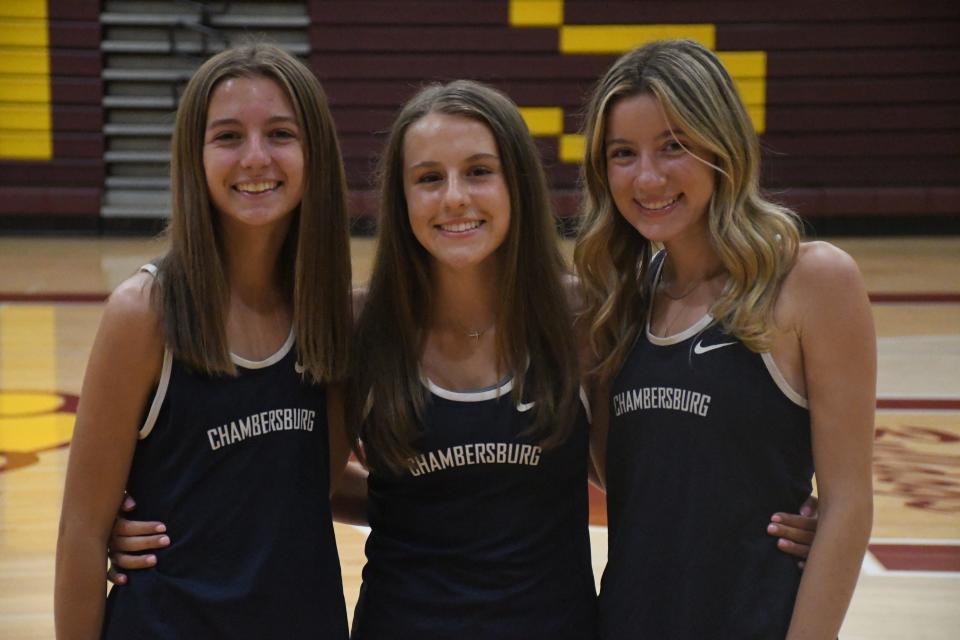 Chambersburg's Lexi Boyd, Mady Koons and Samantha Faust pose for a photo during Mid-Penn Cross Country Media Day at Big Spring High School on Thursday, August 10, 2023