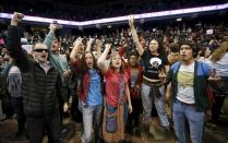 Demonstrators celebrate after Republican U.S. presidential candidate Donald Trump cancelled his rally at the University of Illinois at Chicago March 11, 2016. (REUTERS/Kamil Krzaczynski)