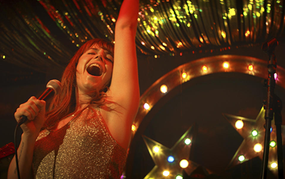 This image released by Neon shows actress Jessie Buckley in a scene from the film, "Wild Rose." Buckley stars as a fiery, working-class Glasgow single mother, just out of prison, who dreams of becoming a country music star. (Neon via AP)