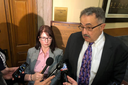 Tammy Cagle, who worked as a court clinician at a special drug court in Pittsfield, Massachusetts, stands beside her lawyer Leonard Kesten (R), following a hearing in the Massachusetts Supreme Judicial Court in Boston, Massachusetts, U.S., April 24, 2018. REUTERS/Nate Raymond