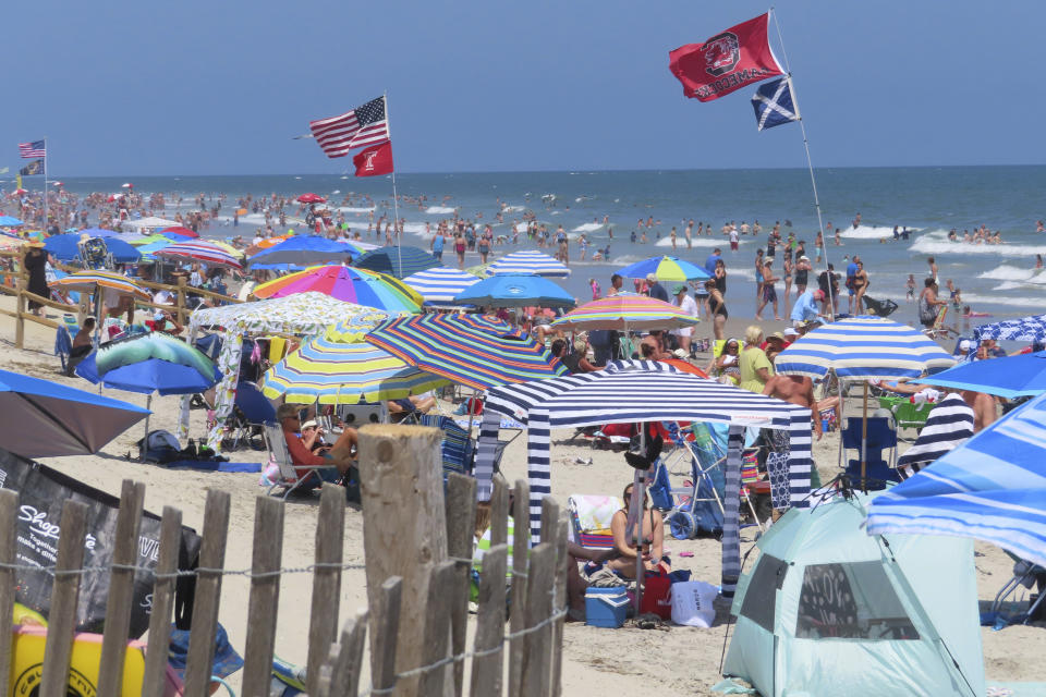 Beachgoers enjoy the sand and surf in North Wildwood N.J. on July 7, 2023. A recent winter storm in January 2024 punched a hole through what is left of the city's eroded dune system, leaving it more vulnerable than ever to destructive flooding as the city and state fight in court over how best to protect the popular beach resort. (AP Photo/Wayne Parry)