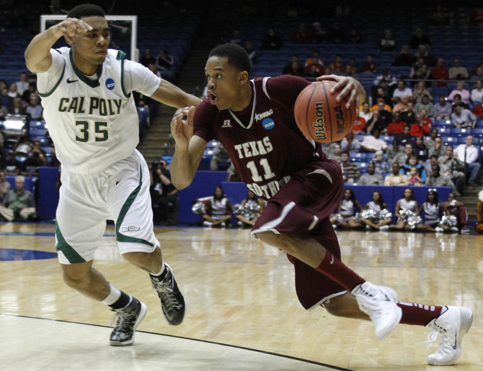 Texas Southern guard Lawrence Johnson-Danner (11) drives against Cal Poly guard Kyle Odister (35) in the first half of a first-round game of the NCAA college basketball tournament on Wednesday, March 19, 2014, in Dayton, Ohio. (AP Photo/Skip Peterson)