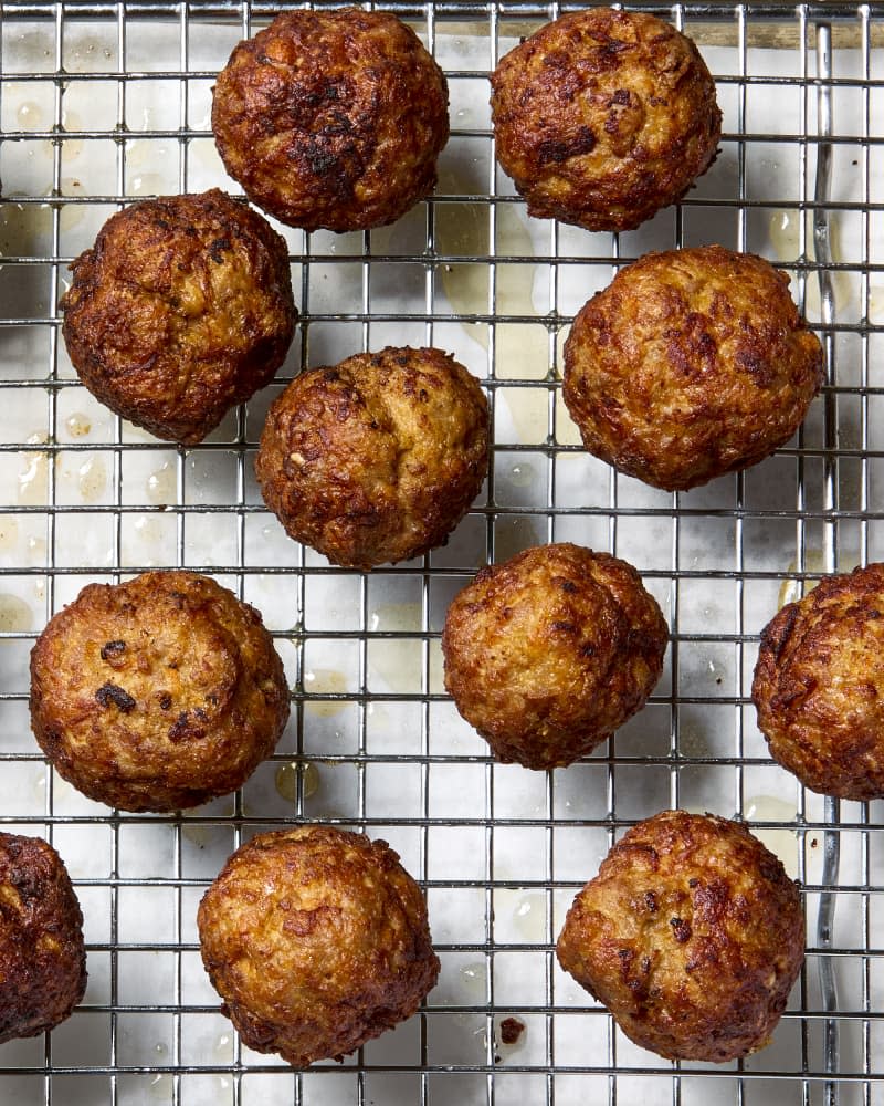 overhead shot of meatballs on a cooling rack.