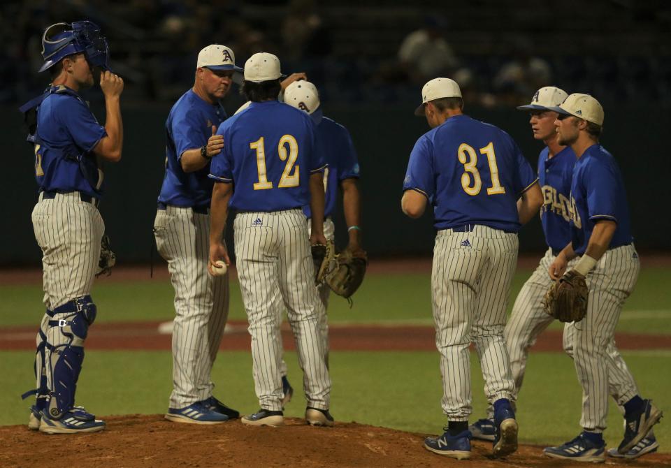 Angelo State University head baseball coach Kevin Brooks, second from left, has a meeting on the mound during Game 1 of an NCAA D-II South Central Super Regional against Colorado Mesa at Foster Field at 1st Community Credit Union Stadium on Friday, May  27, 2022.