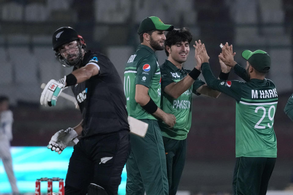 Pakistan's Mohammad Wasim, second right, celebrates with teammates after taking the wicket of New Zealand's Daryl Mitchell, left, during the third one-day international cricket match between Pakistan and New Zealand, in Karachi, Pakistan, Wednesday, May 3, 2023. (AP Photo/Fareed Khan)
