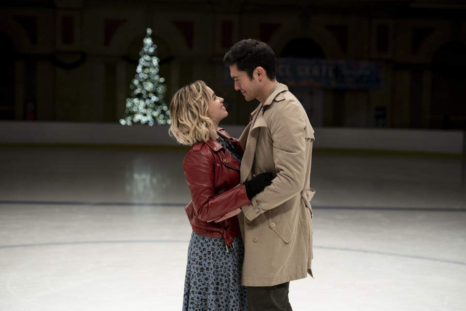 This image released by Universal Pictures shows Emilia Clarke, left, and Henry Golding in a scene from "Last Christmas." (Jonathan Prime/Universal Pictures via AP)