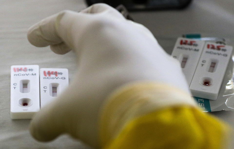 A health worker collects blood samples as they conduct mass testing for the COVID-19 in Manila, Philippines on Friday, May 8, 2020. The whole of metropolitan Manila is still under enhanced community quarantine to help prevent the spread of the new coronavirus. (AP Photo/Aaron Favila)