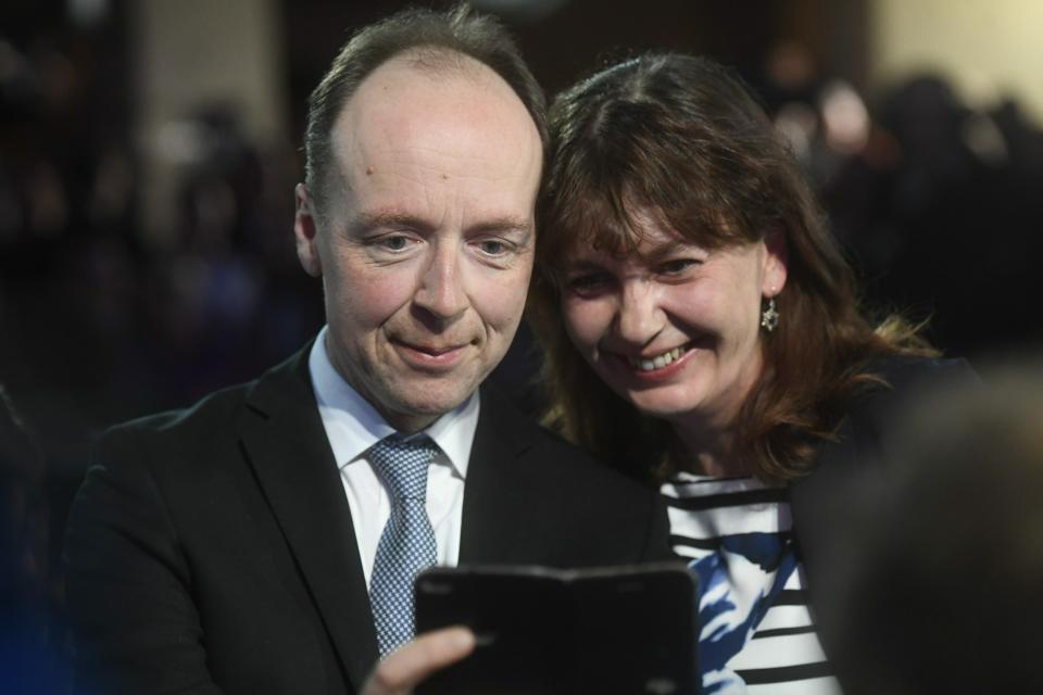 Chairman of The Finns Party Jussi Halla-aho, left and Party Secretary Riikka Slunga-Poutsalo attend The Finns Party parliamentary election party iin Helsinki, Sunday, April 14, 2019. Voters in Finland are casting ballots in a parliamentary election Sunday after climate change dominated the campaign, even overshadowing topics like reforming the nation's generous welfare model. (Vesa Moilanen/Lehtikuva via AP)