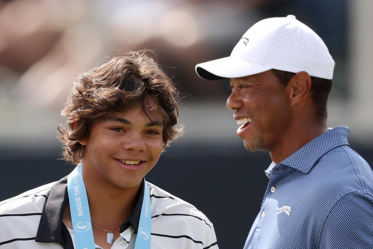 Charlie Woods, seen here with his father Tiger at last week's U.S. Open, has qualified to compete in a USGA championship event. (Gregory Shamus/Getty Images)