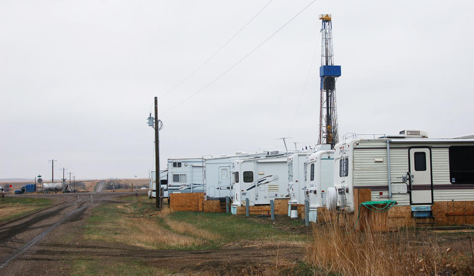 In this April 19, 2012, photo trailers used as temporary housing for oil industry workers are are parked along a dirt road outside Dore, N.D. The western North Dakota town has seen an economic and population turnaround with increased oil activity in the region. (AP Photo/ James MacPherson)