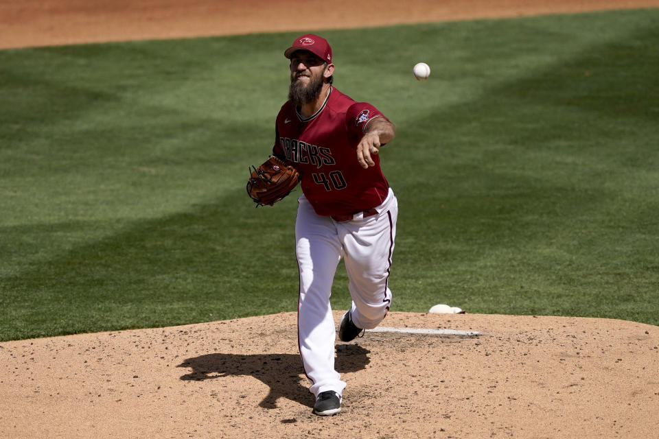 Arizona Diamondbacks starting pitcher Madison Bumgarner (40) throws against the Texas Rangers during the thirdinning of a spring training baseball game Tuesday, March 22, 2022, in Scottsdale, Ariz. (AP Photo/Matt York)