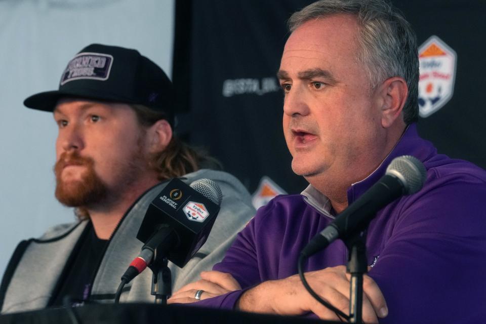 TCU Horned Frogs head coach Sonny Dykes and offensive lineman Wes Harris speak to the press after arriving at Sky Harbor International Airport on Saturday, Dec. 24, 2022, ahead of their College Football Playoff Semifinal at the Vrbo Fiesta Bowl against the Michigan Wolverines. 