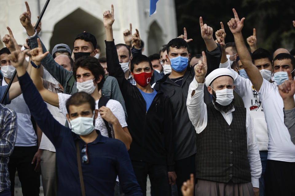 Demonstrators chant slogans during an anti-France protest in Istanbul, Sunday, Oct. 25, 2020. Turkish President Recep Tayyip Erdogan on Sunday challenged the United States to impose sanctions against his country while also launching a second attack on French President Emmanuel Macron. Speaking a day after he suggested Macron needed mental health treatment because of his attitude to Islam and Muslims, which prompted France to recall its ambassador to Ankara, Erdogan took aim at foreign critics. (AP Photo/Emrah Gurel)