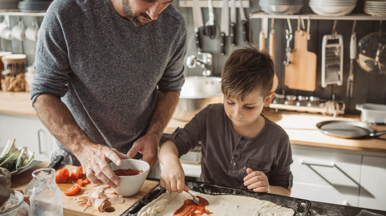 Man and child cooking together