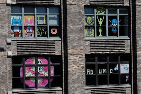 Images created with Post-it notes are seen in the windows of offices at 75 Varick Street in lower Manhattan, New York, U.S., May 18, 2016, where advertising agencies and other companies have started what is being called a "Post-it note art war" with employees creating colorful images in their windows with Post-it notes. REUTERS/Mike Segar