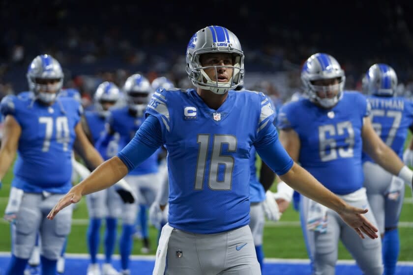 Detroit Lions quarterback Jared Goff (16) welcomes teammates onto the field.